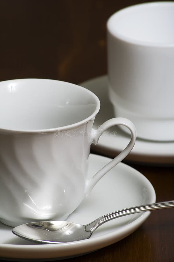 Empty white coffee cups with saucers with a shallow DOF. Empty white coffee cups with saucers with a shallow DOF