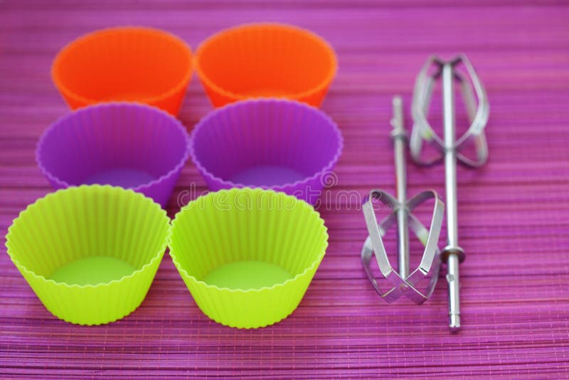 Colorful silicone baking cups on purple background. Colorful silicone baking cups on purple background