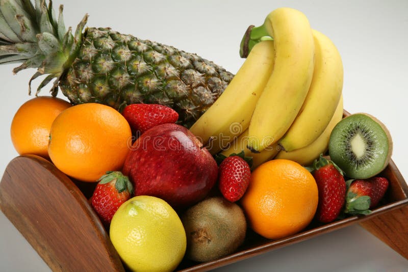 A wood made fruit bowl with fresh fruits. A wood made fruit bowl with fresh fruits