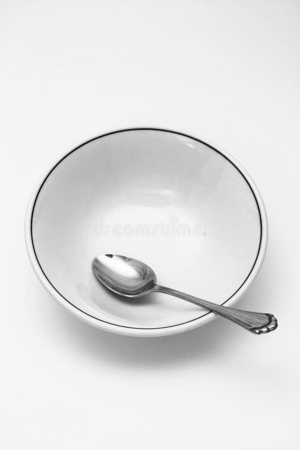 Spoon and empty cereal bowl. Spoon and empty cereal bowl