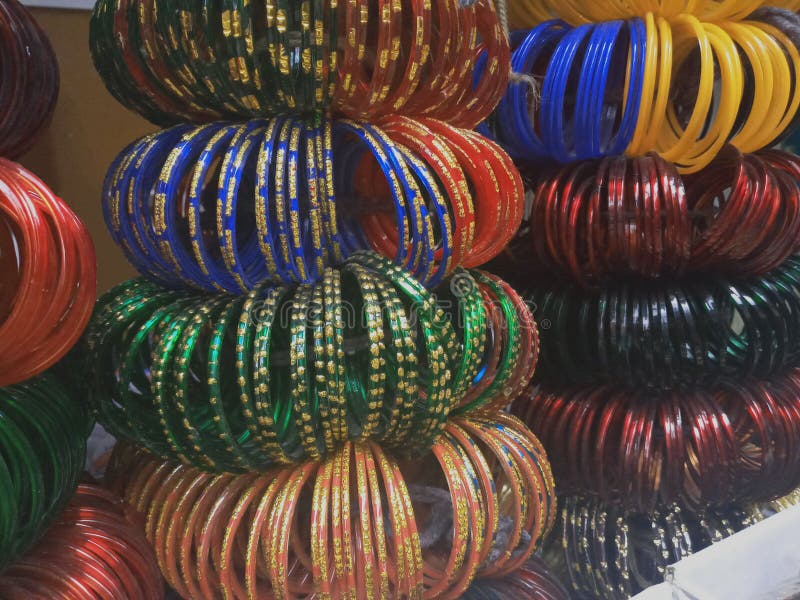 Colourful glass bangles close up. Bangles neatly stacked  in a shop, for sale in  Bengaluru India . Ethnic handmade  item. Gift souvenir items. Fashion bracelet jewellery. Colourful glass bangles close up. Bangles neatly stacked  in a shop, for sale in  Bengaluru India . Ethnic handmade  item. Gift souvenir items. Fashion bracelet jewellery