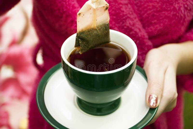 Tea bag with a cup of tea stock photo. Image of green 23210936