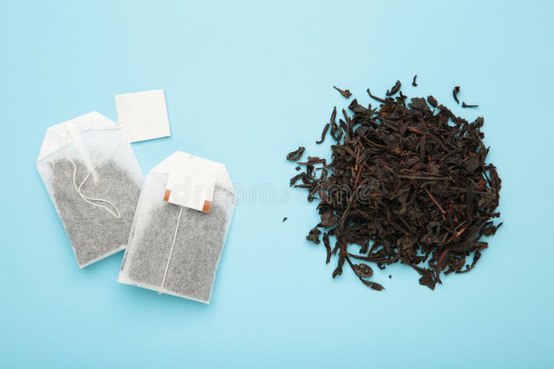 Tea Bag and with Dry Tea Leaves on Blue Background Stock Photo Image