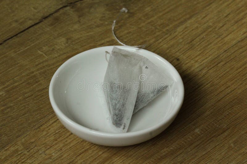 Tea bag on plate stock photo. Image of saucer, glass 109739656