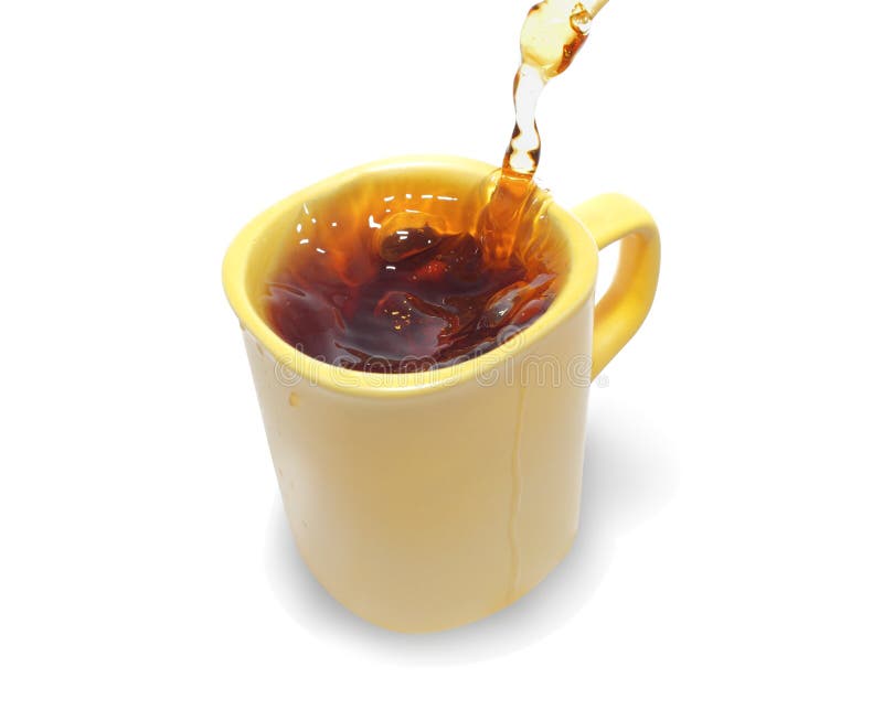 Tea being poured into tea cup on a white