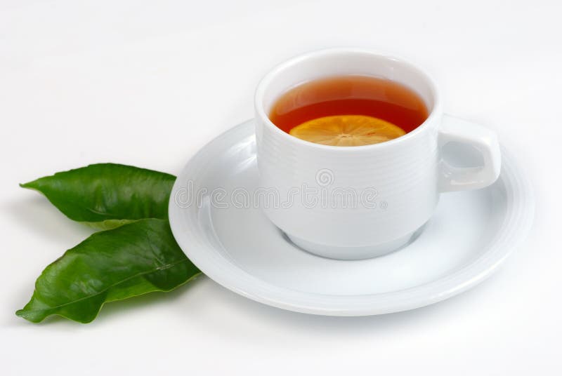Tea cup and leaves of lemon stock image