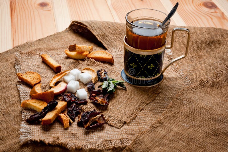 Tea in a Glass Cup with a Cup Holder, Served in a Rustic Style, Shot on