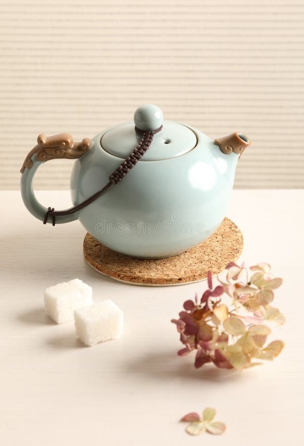 Tea kettle on a white table stock images