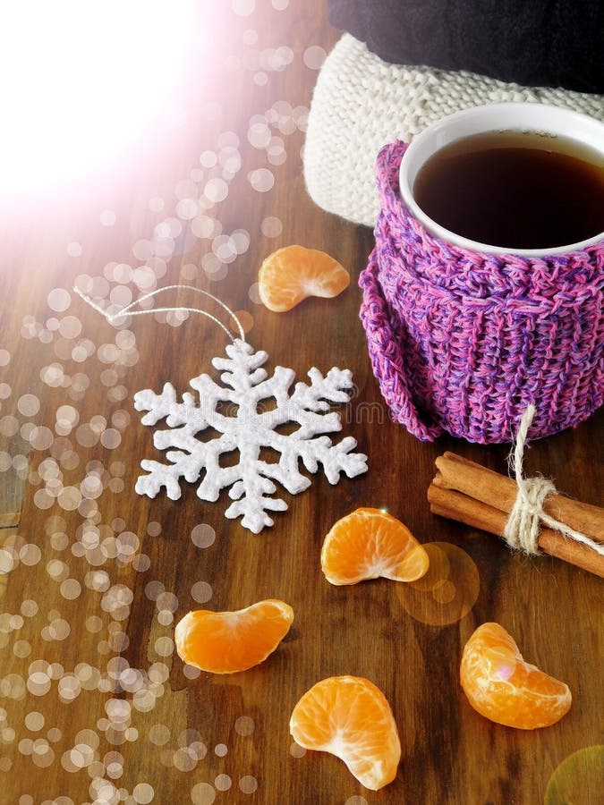 Tea in a Mug Wrapped into Tiny Scarf Surrounded by Mandarin Segments