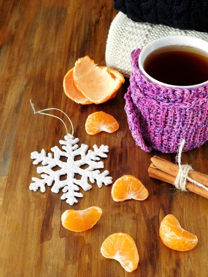 Tea in a Mug Wrapped into Tiny Scarf Surrounded by Mandarin Segments