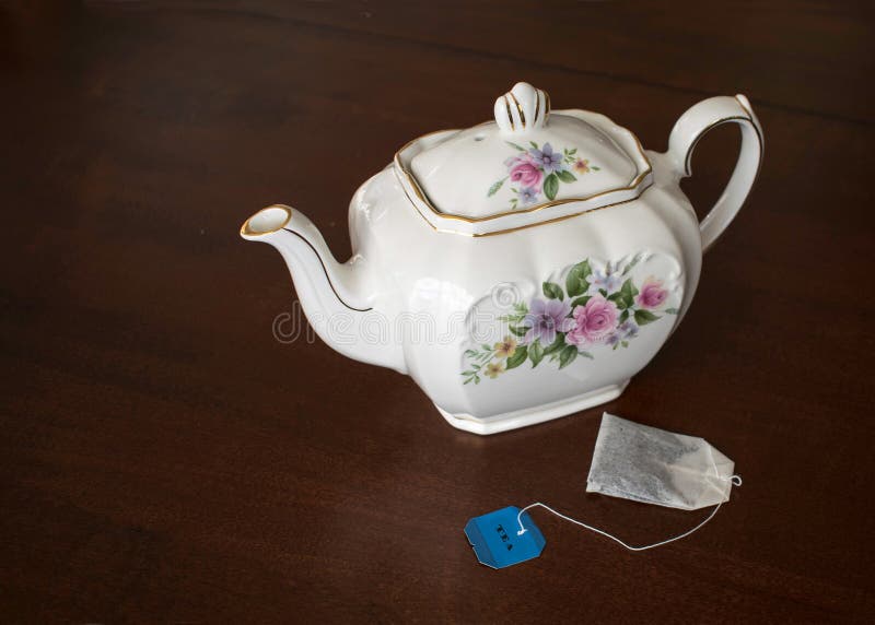 Tea Pot and Tea Bag on Dark Wood Table Stock Image Image of pretty