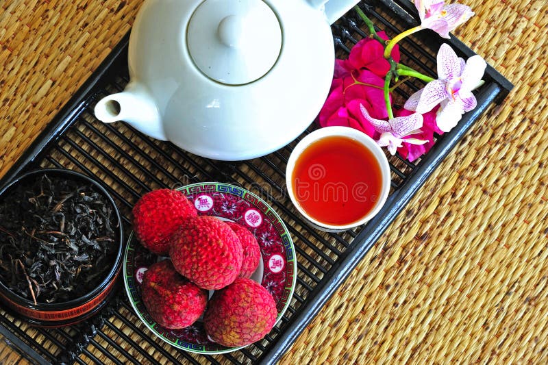 Tea set with chinese tea and litchees stock images