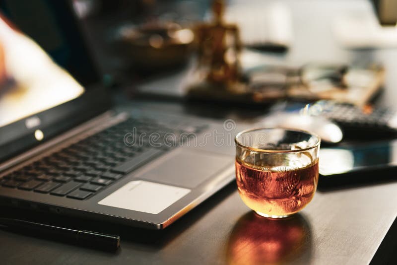 Tea Time Concept . Tea Cup on Office Table with Laptop Computer Stock