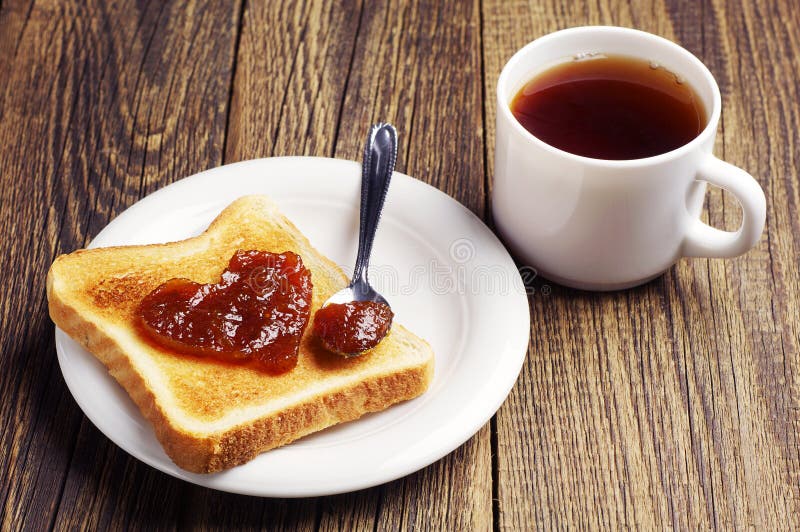 Tea and toast bread with jam in shape of hearts