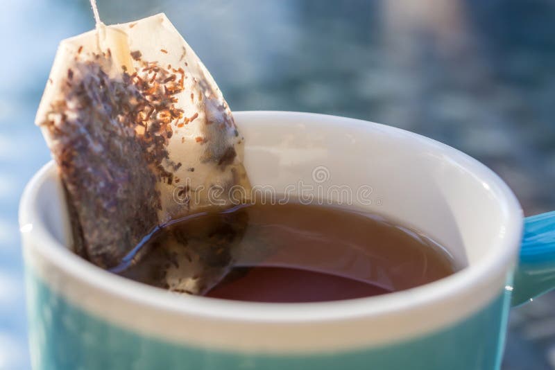 Closeup of a cup full of tea from which the teabag is just removed. Closeup of a cup full of tea from which the teabag is just removed