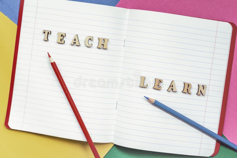Teach and learn, words in open notebook, colored paper sheets. Concept of education, starting school, back to school stock photos Teach and learn, words in open notebook, colored paper sheets. Concept of education, starting school, back to school stock photos