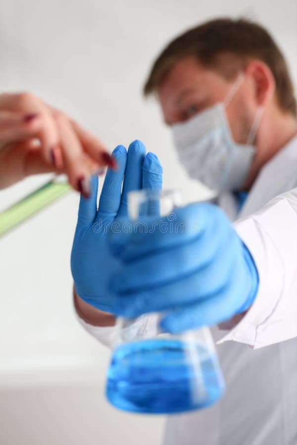 A Male Chemist Holds Test Tube of Glass in His Hand Overflows a Liquid