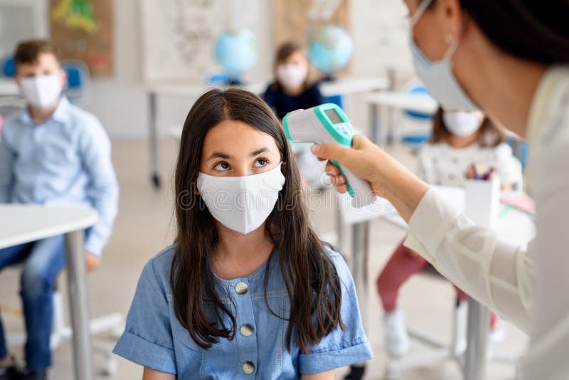 Teacher, children with face mask at school after covid-19 quarantine and lockdown. Teacher, children with face mask at school after covid-19 quarantine and royalty free stock photos