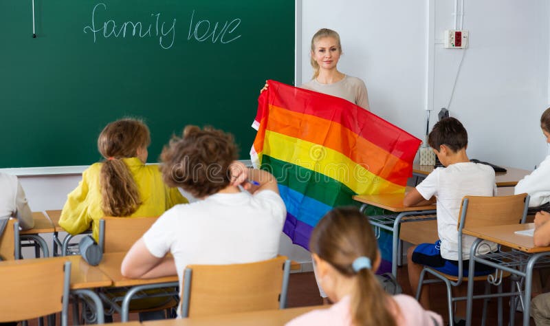 Teacher explaining LGBT flag meaning for kids during lesson