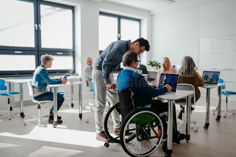 Teacher explaining senior students how to work with laptop and internet. Elderly people attending computer and royalty free stock photos