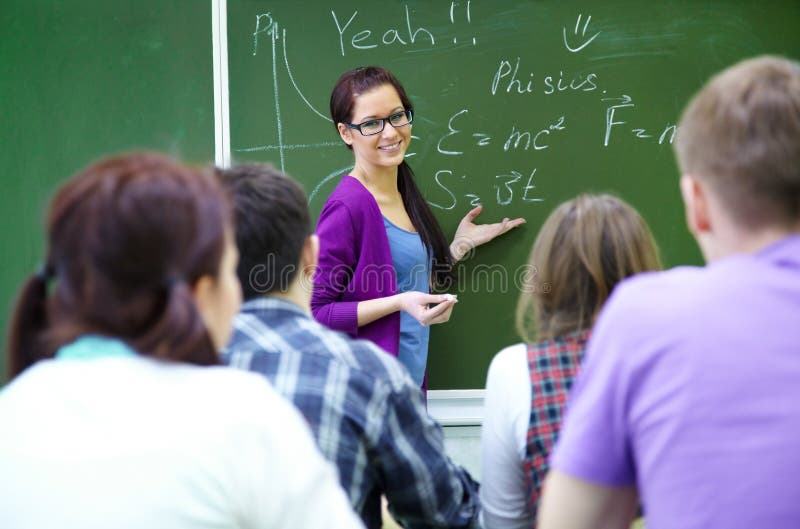 Teacher with group of students in classroom stock photo