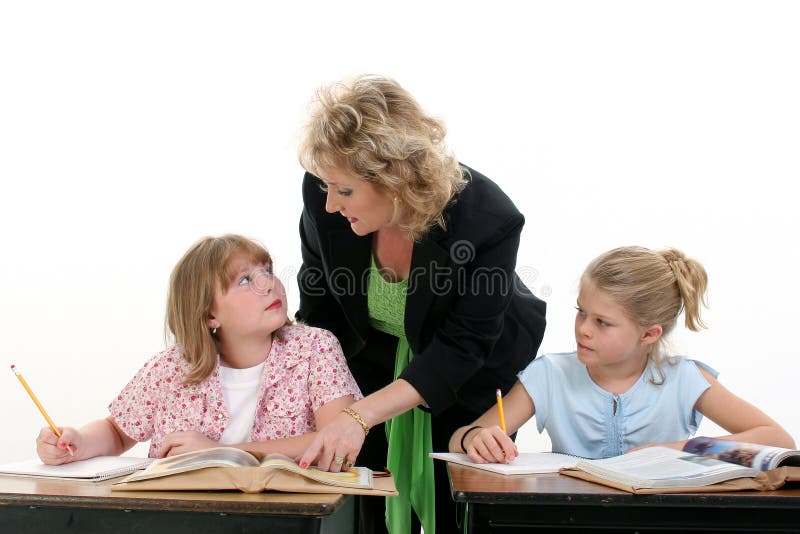 Teacher Helping Child in Classroom