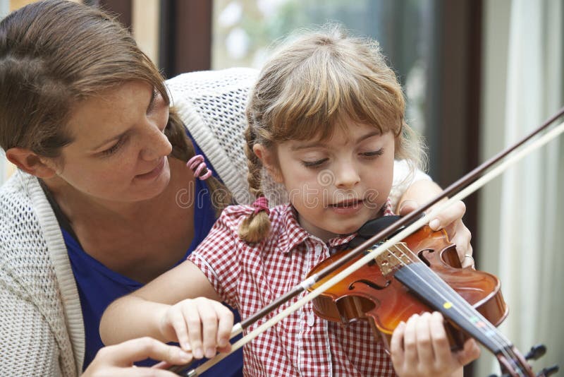 Teacher Helping Female Student To Play Trumpet In Music Lesson ...