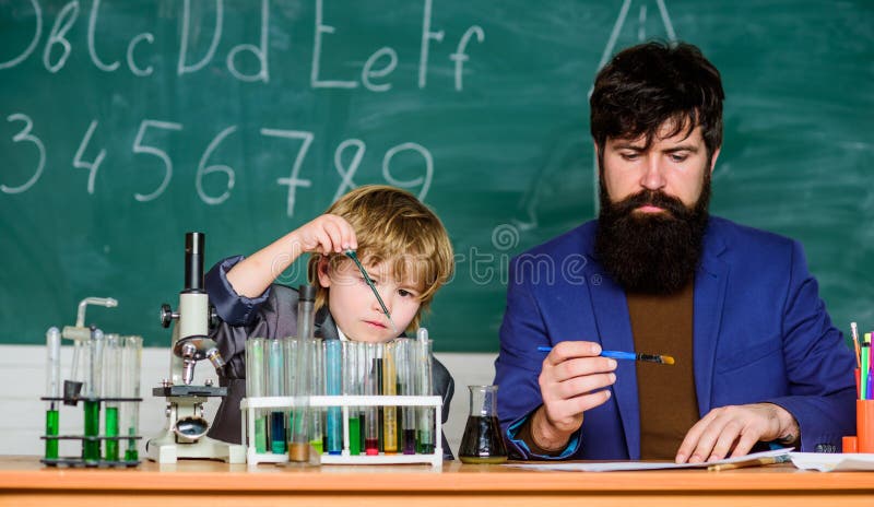 Teacher man with little boy. school lab equipment. Back to school. father and son at school. using microscope in lab royalty free stock images Teacher man with little boy. school lab equipment. Back to school. father and son at school. using microscope in lab royalty free stock images