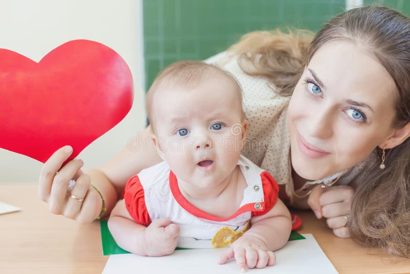 Teacher near blackboard teaching child, baby. Preschool royalty free stock image Teacher near blackboard teaching child, baby. Preschool royalty free stock image