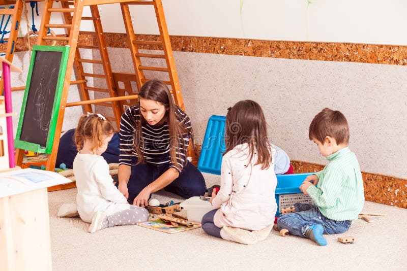 Teacher is playing with kids. royalty free stock photos Teacher is playing with kids. royalty free stock photos