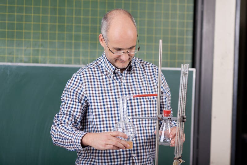 Teacher preparing a chemistry experiment royalty free stock images