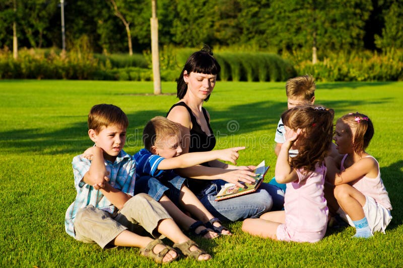 Teacher reading to kids royalty free stock photography