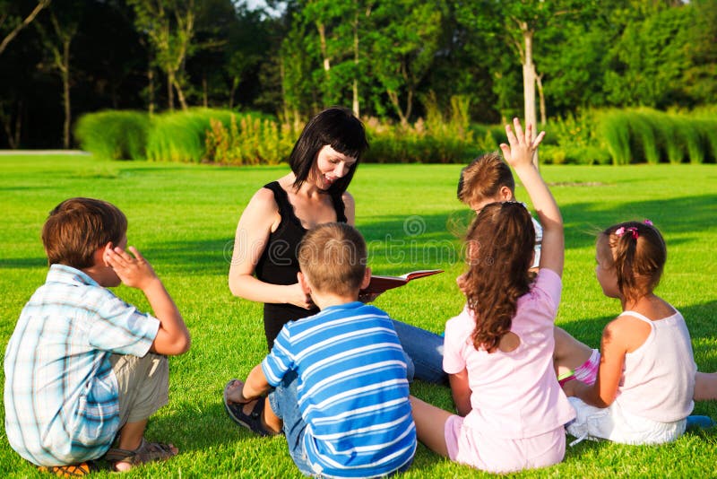 Teacher reading to kids stock photos