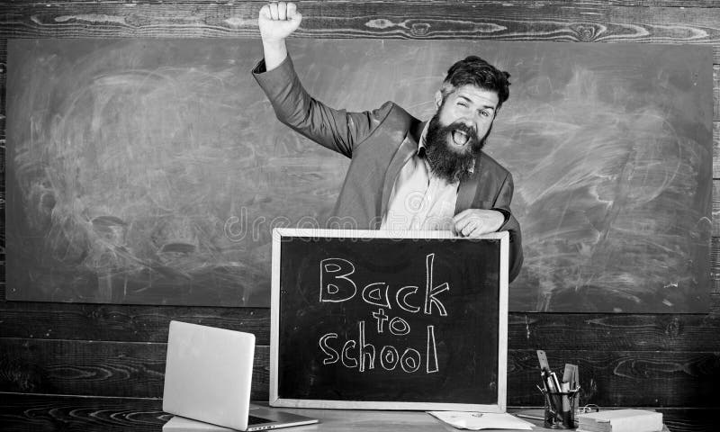 Teacher or school principal welcomes inscription back to school. Teaching pupils his professional occupation. Teacher royalty free stock image Teacher or school principal welcomes inscription back to school. Teaching pupils his professional occupation. Teacher royalty free stock image