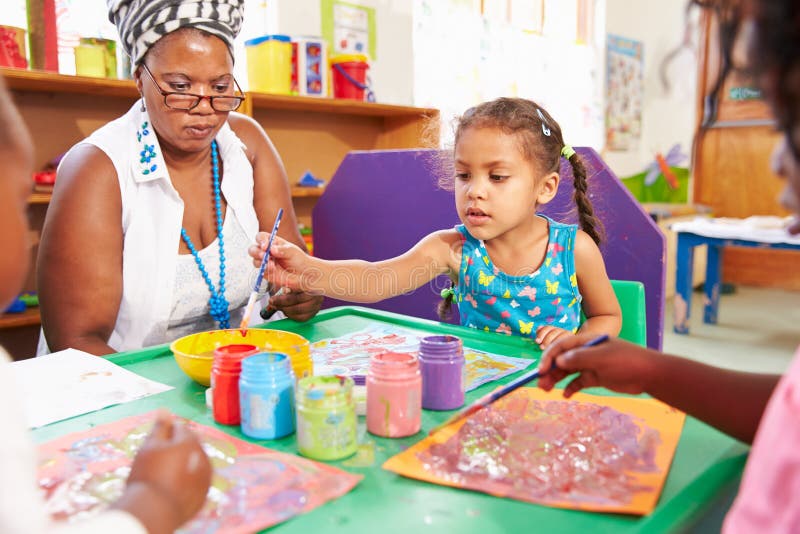 Teacher sitting with kids in a preschool class, close up stock photos Teacher sitting with kids in a preschool class, close up stock photos