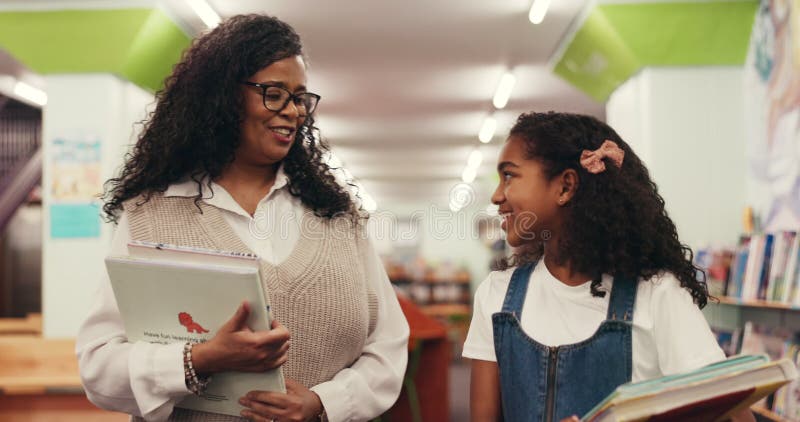 Teacher, student and walking with books in library for tutoring appointment, learning support and chat. Education, tutor stock footage