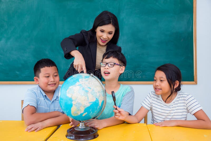 Teacher and students studying geography in class royalty free stock photography
