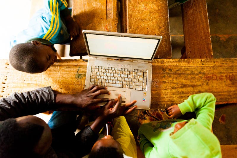 teacher teaching children to use computer in school. teacher teaching children to use computer in school