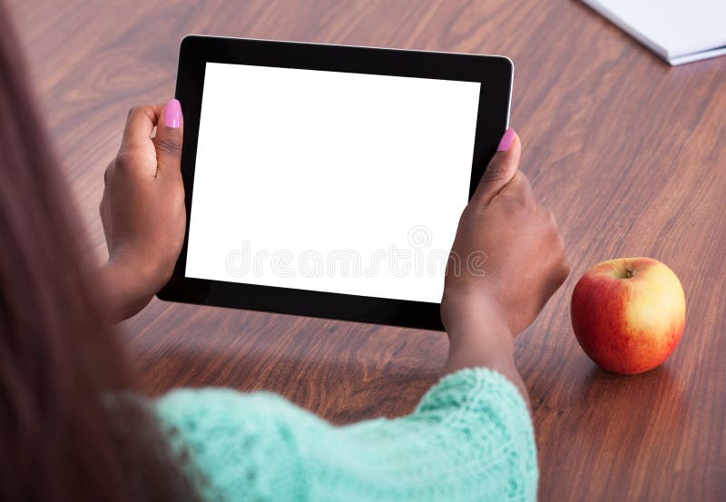 Teacher Using Digital Tablet At Classroom