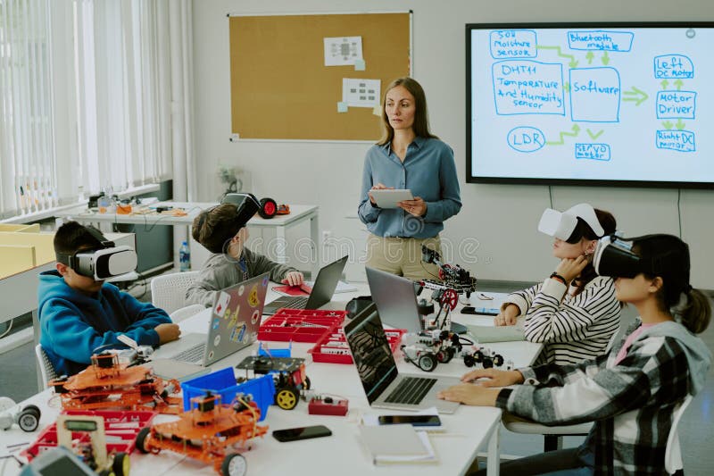 Teacher Watching Student in Classroom stock photography