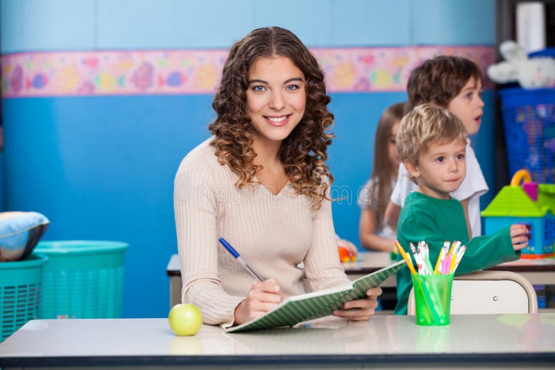 Teacher Writing In Book royalty free stock photos Teacher Writing In Book royalty free stock photos