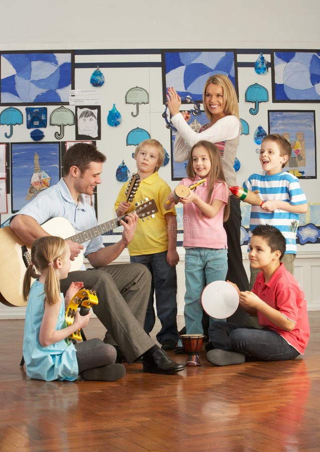 Teachers Playing Guitar With Pupils stock image Teachers Playing Guitar With Pupils stock image