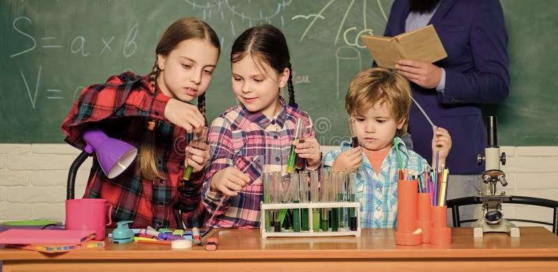 Teaching kids sharing important knowledge. With experience comes knowledge. Formal education. Chemistry classes. Group stock photos