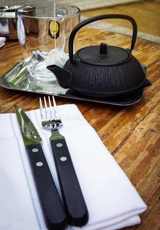 Teacup, Teapot, Fork and Knife on a Table in Cafe Stock Photo Image