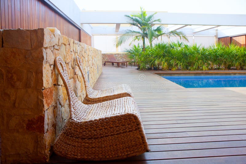Teak wood house outdoor with swing chairs and pool royalty free stock photos Teak wood house outdoor with swing chairs and pool royalty free stock photos