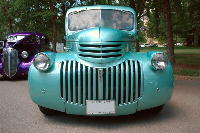 Teal hot rod car at a car show.