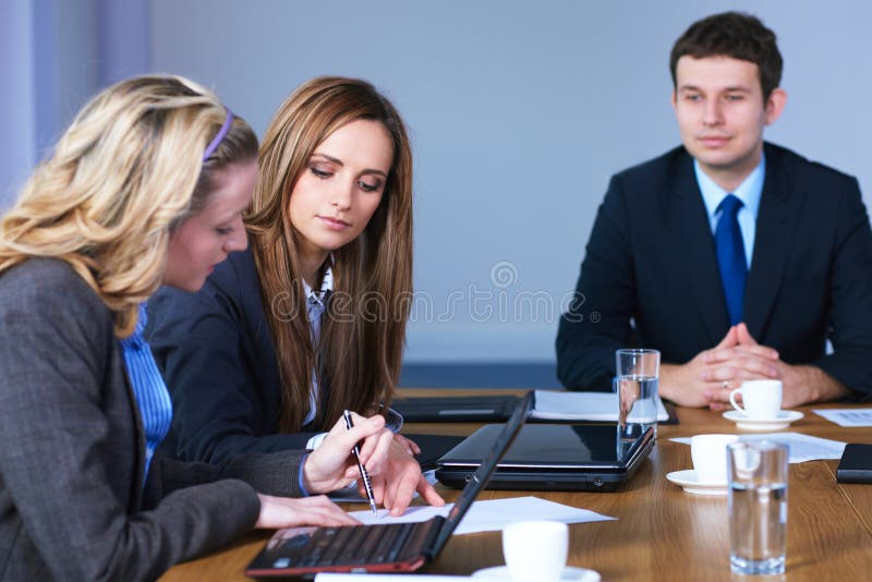 Team of 3 business people sitting at table