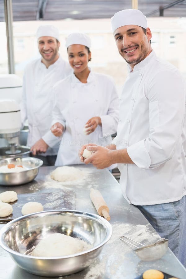 Team Of Bakers Preparing Dough And Pastry Stock Photo - Image of