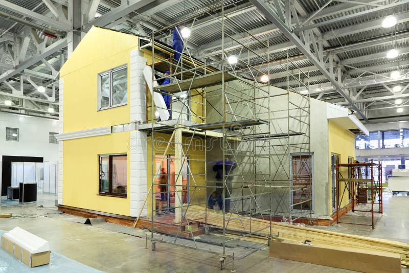 Team of builders build cottage royalty free stock images Team of builders build cottage royalty free stock images