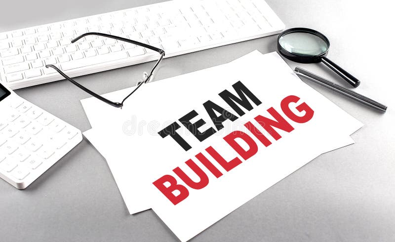 TEAM BUILDING text on paper with keyboard, calculator on grey background royalty free stock photo